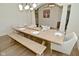 Bright dining room offers hardwood floors, modern lighting, large windows, and a wooden table with a bench at 728 Christin Ct, Plainfield, IN 46168