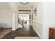Open hallway with dark floors, white walls and trim, leading to the living and staircase at 728 Christin Ct, Plainfield, IN 46168