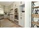 Bright kitchen with stainless steel appliances, white cabinets and hardwood floors at 728 Christin Ct, Plainfield, IN 46168