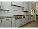 Close up of the kitchen with stainless steel range and oven and light gray subway tile backsplash at 728 Christin Ct, Plainfield, IN 46168