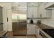 Kitchen features a stainless steel refrigerator and granite countertops with light gray cabinets at 728 Christin Ct, Plainfield, IN 46168