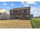 Two-story home featuring large backyard with sliding glass door entrance at 7417 Waylon Way, Indianapolis, IN 46239