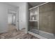Modern bathroom featuring a glass-enclosed shower, wood-look flooring, and white trim at 7417 Waylon Way, Indianapolis, IN 46239