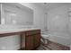 Bright bathroom featuring a large mirror, single sink vanity and a shower-tub combination with a white surround at 7417 Waylon Way, Indianapolis, IN 46239
