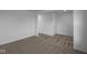 A carpeted bedroom with white walls with hard surface flooring that leads to another room with white walls and trim at 7417 Waylon Way, Indianapolis, IN 46239