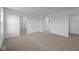 A spacious bedroom offers neutral carpet, three doorways, and a bright window with natural light at 7417 Waylon Way, Indianapolis, IN 46239