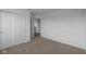 Bedroom features neutral carpet, white walls, trim, a closet and a doorway to another room at 7417 Waylon Way, Indianapolis, IN 46239