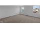 This bedroom showcases a light brown carpet, complemented by white walls and trim, with natural light from exterior at 7417 Waylon Way, Indianapolis, IN 46239