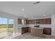 Well-lit kitchen with stainless steel appliances and an island, flowing seamlessly into the dining area at 7417 Waylon Way, Indianapolis, IN 46239