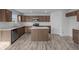 Well-lit kitchen with stainless steel appliances and an island, flowing seamlessly into the dining area at 7417 Waylon Way, Indianapolis, IN 46239