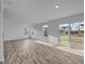 Spacious living room with plank floors, natural light and a sliding glass door at 7417 Waylon Way, Indianapolis, IN 46239