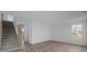 Bright living room with stylish wood floors, gray staircase and abundant natural light from large windows at 7417 Waylon Way, Indianapolis, IN 46239