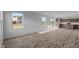 Spacious living room with plank floors, natural light and a sliding glass door at 7417 Waylon Way, Indianapolis, IN 46239