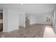 Open-concept room with plank floors and a staircase, flowing seamlessly into the kitchen area at 7417 Waylon Way, Indianapolis, IN 46239