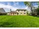 Expansive, green backyard featuring lush grass and mature trees, providing a private and serene outdoor space at 7423 Scarborough Blvd E Dr, Indianapolis, IN 46256
