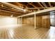 Unfinished basement with concrete floors and wood-paneled walls, offering potential for customization at 7423 Scarborough Blvd E Dr, Indianapolis, IN 46256