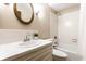 This bathroom features a vanity with mirror, sink, and toilet, as well as a combined bathtub and shower at 7423 Scarborough Blvd E Dr, Indianapolis, IN 46256