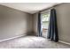 Bright and airy bedroom with soft carpet flooring, complemented by natural light from the windows at 7423 Scarborough Blvd E Dr, Indianapolis, IN 46256