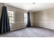 Spacious bedroom illuminated by two windows with soft carpeting, and neutral paint at 7423 Scarborough Blvd E Dr, Indianapolis, IN 46256