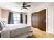 This bedroom features a ceiling fan, hardwood floors, large closet and comforting natural light at 7423 Scarborough Blvd E Dr, Indianapolis, IN 46256