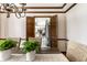 Elegant dining room with rustic table, flowing into the living room and kitchen through shuttered doors at 7423 Scarborough Blvd E Dr, Indianapolis, IN 46256