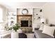 Close-up of the living room fireplace featuring a stone surround, built-in shelving, and stylish decor at 7423 Scarborough Blvd E Dr, Indianapolis, IN 46256