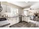 Bright kitchen with white cabinets, gray countertops, stainless steel appliances and eat in breakfast bar at 7423 Scarborough Blvd E Dr, Indianapolis, IN 46256
