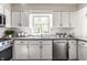 Beautiful kitchen featuring white cabinets, stainless steel appliances and a window overlooking the backyard at 7423 Scarborough Blvd E Dr, Indianapolis, IN 46256