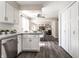 Modern kitchen with white cabinets, stainless steel appliances and open layout to the dining and living spaces at 7423 Scarborough Blvd E Dr, Indianapolis, IN 46256