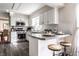 Open kitchen with stainless steel appliances, breakfast bar, and seamlessly flows into the dining area at 7423 Scarborough Blvd E Dr, Indianapolis, IN 46256