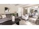 Comfortable living room area with stylish furnishings, flowing into dining area and adjacent kitchen at 7423 Scarborough Blvd E Dr, Indianapolis, IN 46256