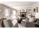 Comfortable living room with stone fireplace, built-in shelves, and neutral decor, creating a warm and inviting space at 7423 Scarborough Blvd E Dr, Indianapolis, IN 46256