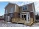 Two-story home featuring a wood deck and sliding doors surrounded by tan vinyl siding and brick at 7522 Timberfield Ln, Indianapolis, IN 46259