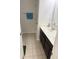 Well-lit bathroom with dual sinks, a vanity, and a towel rack at 7522 Timberfield Ln, Indianapolis, IN 46259
