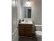 Bathroom with a wood vanity, toilet, and white countertop at 7522 Timberfield Ln, Indianapolis, IN 46259