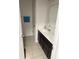 Well-lit bathroom with dual sinks, a vanity, and a towel rack at 7522 Timberfield Ln, Indianapolis, IN 46259