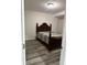 Bedroom with a dark wood bed frame, and grey vinyl plank floors at 7522 Timberfield Ln, Indianapolis, IN 46259