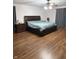 Bedroom with hardwood floors, natural lighting, and a large bed at 7522 Timberfield Ln, Indianapolis, IN 46259