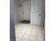 Tiled entryway featuring a white door, coat hooks, and neutral color scheme at 7522 Timberfield Ln, Indianapolis, IN 46259