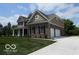 Charming two-story home featuring brick accents, a well-manicured lawn and attached two car garage at 7522 Timberfield Ln, Indianapolis, IN 46259