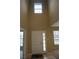 Bright foyer with tall ceilings, a front door with sidelight, and transom window at 7522 Timberfield Ln, Indianapolis, IN 46259