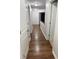 Hallway with hardwood floors and white walls leading to other rooms in the home at 7522 Timberfield Ln, Indianapolis, IN 46259