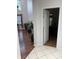 A view of the hallway and an open bedroom entrance with hardwood floors and neutral paint colors at 7522 Timberfield Ln, Indianapolis, IN 46259