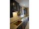 Kitchen features dark cabinets, granite countertops, and stainless steel appliances at 7522 Timberfield Ln, Indianapolis, IN 46259