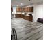 Open kitchen with stainless steel appliances, ample cabinet space, and gray wood flooring at 7522 Timberfield Ln, Indianapolis, IN 46259