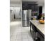Kitchen with stainless steel refrigerator, tile flooring, and granite countertops at 7522 Timberfield Ln, Indianapolis, IN 46259