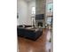 A cozy living room featuring a stone fireplace, hardwood floors, and a large sectional sofa at 7522 Timberfield Ln, Indianapolis, IN 46259
