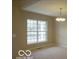 Bright living room with carpeted floors, a large window, and a chandelier at 7522 Timberfield Ln, Indianapolis, IN 46259