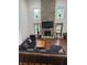 Open-concept living room showcases a floor-to-ceiling stone fireplace, wood floors, and expansive sectional seating at 7522 Timberfield Ln, Indianapolis, IN 46259