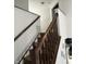 View of staircase with a wooden handrail and white walls, leading to the upper level of the home at 7522 Timberfield Ln, Indianapolis, IN 46259